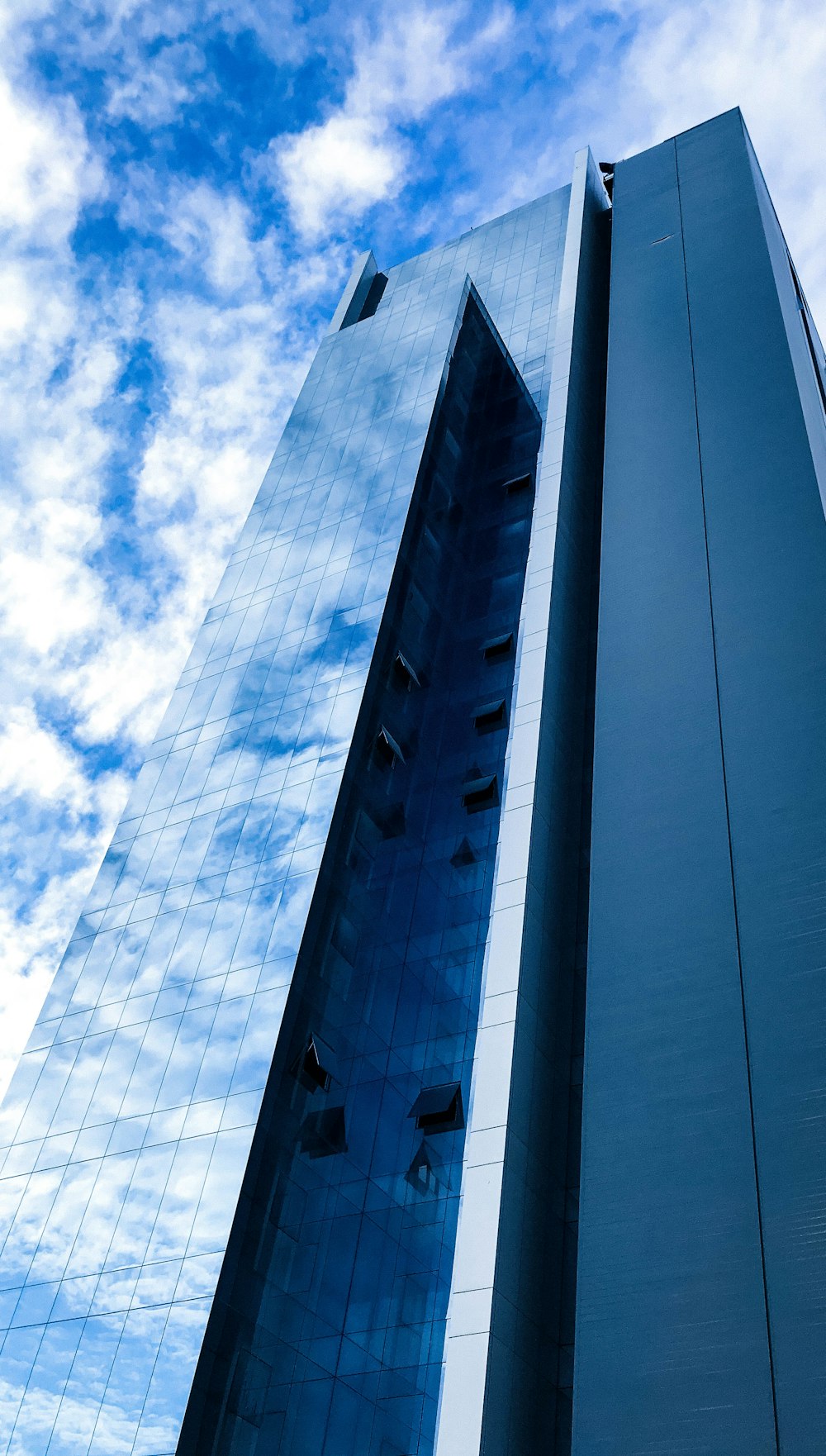 white clouds over glass building