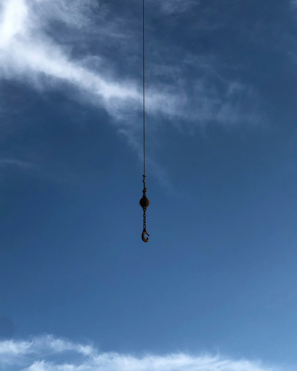 orange and black hanging decor under blue sky during daytime