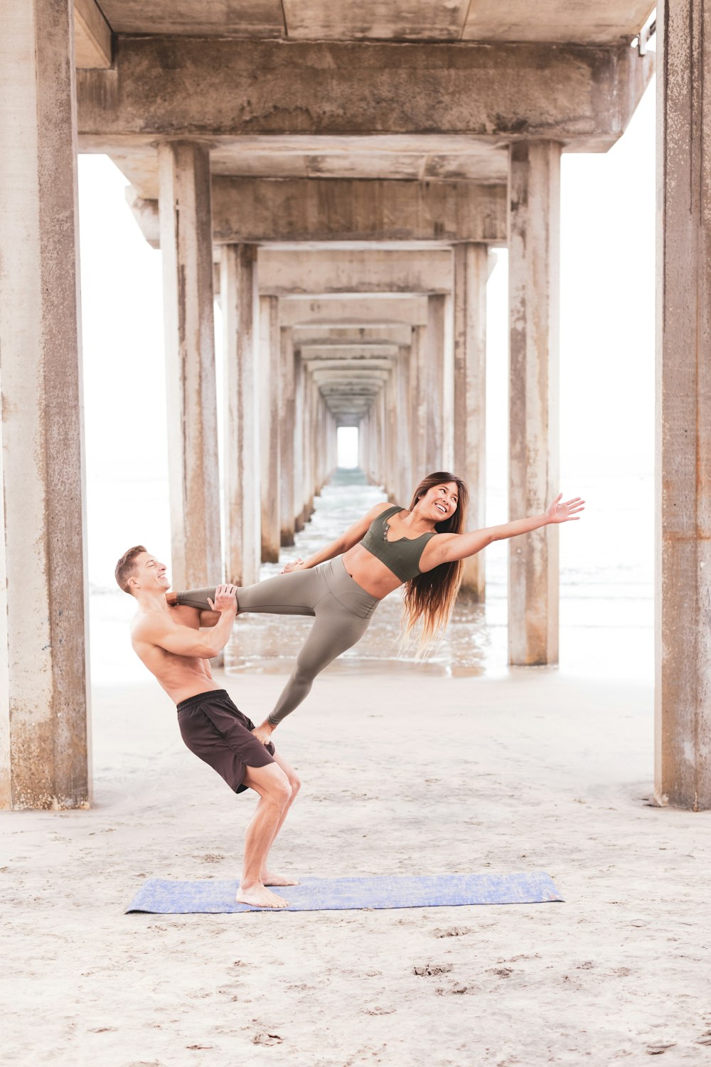 2 women in black tank top and black shorts running on gray concrete floor during daytime