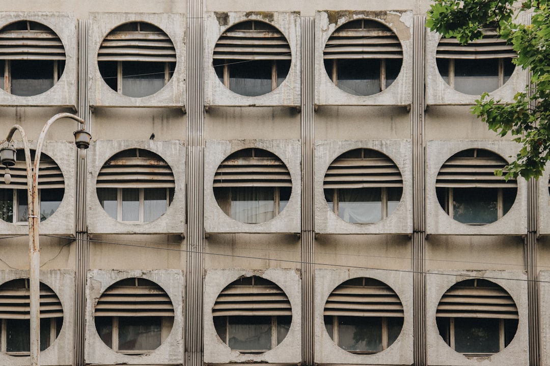 brown concrete building with glass windows