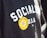 Text on a black garment says 'SOCIALISM D.S.A.' with a bright yellow circular sticker on it. The sticker features a flower design with the text 'DANDELION UNION ILWU LOCAL 6'.