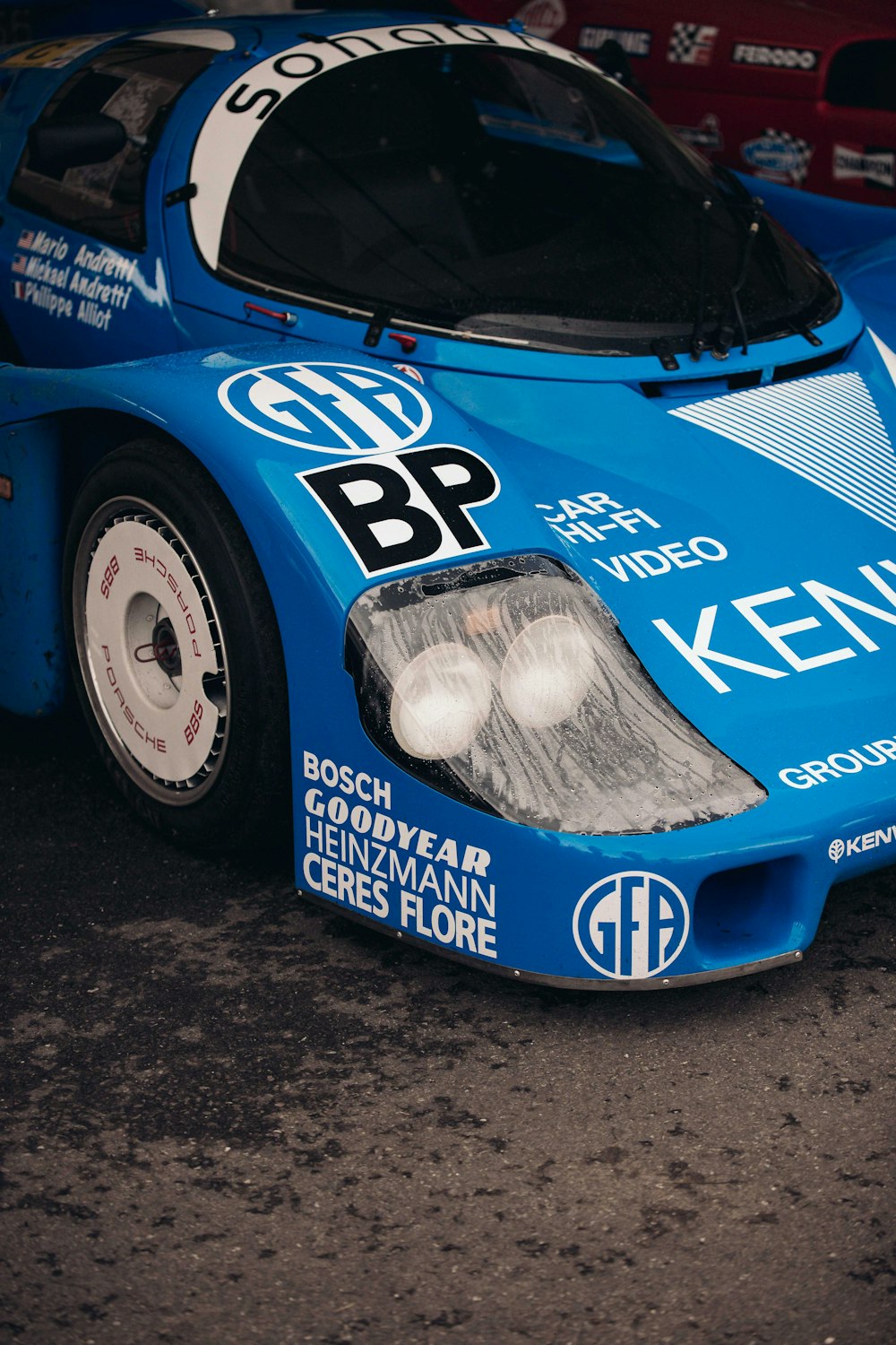 a blue race car parked in a parking lot