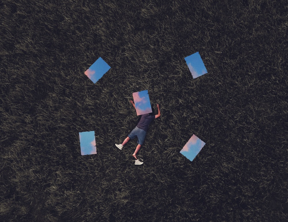 a man laying in the grass with a frisbee