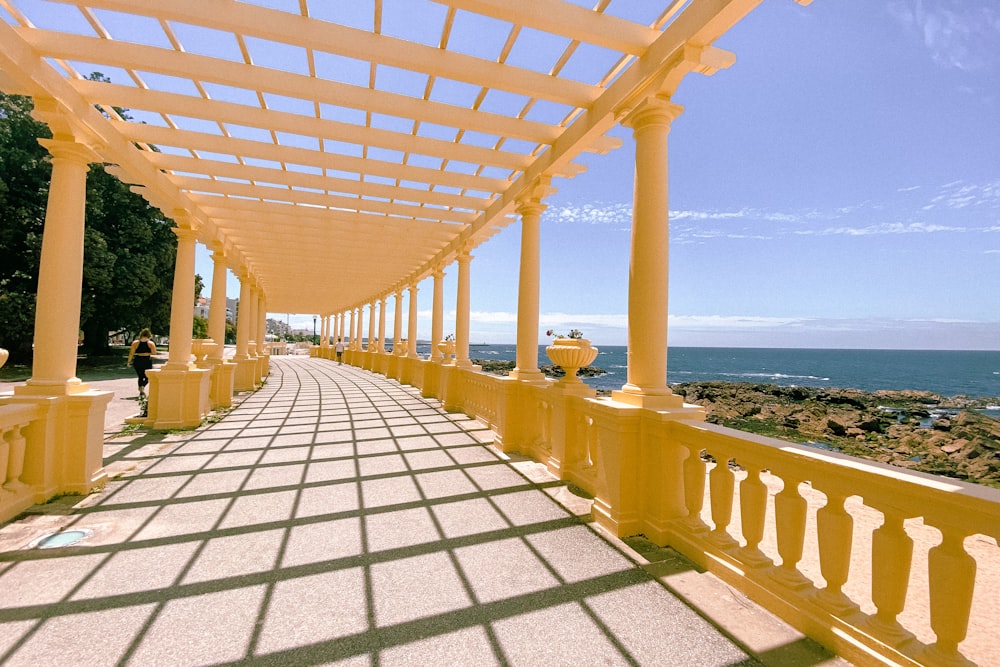 brown wooden bridge over the sea during daytime