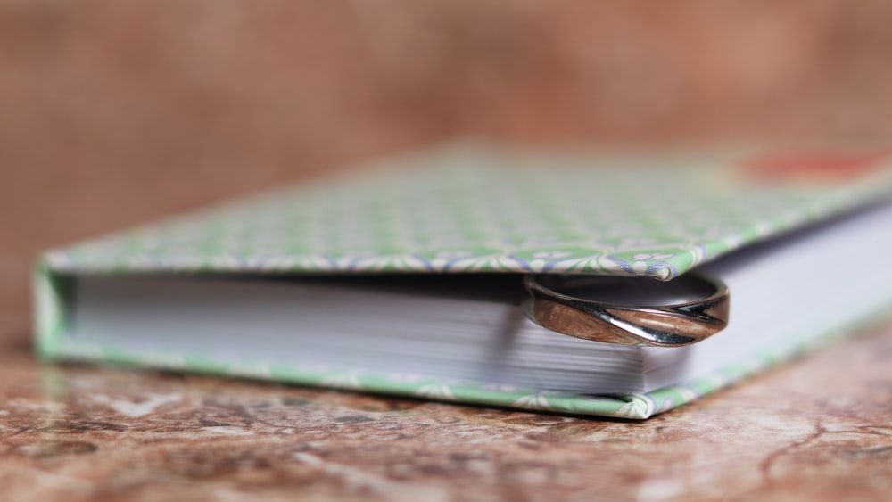 green book on brown wooden table