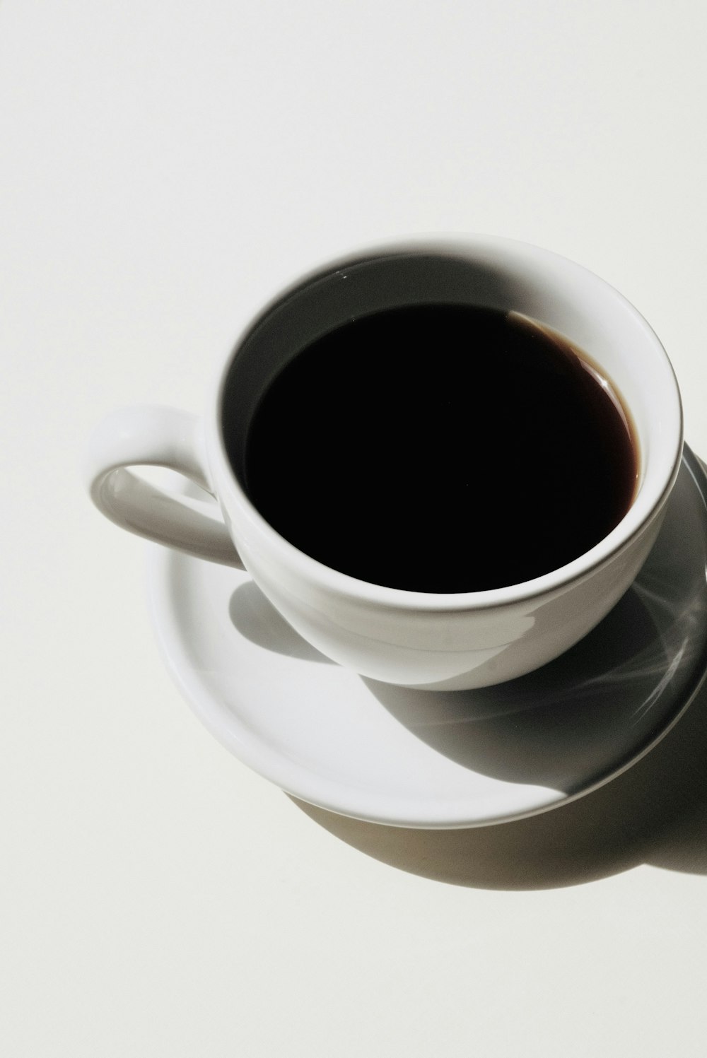 white ceramic mug with black liquid