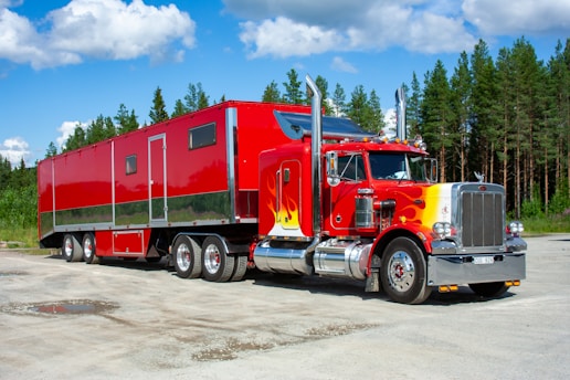 red and white truck on road during daytime