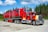 red and white truck on road during daytime
