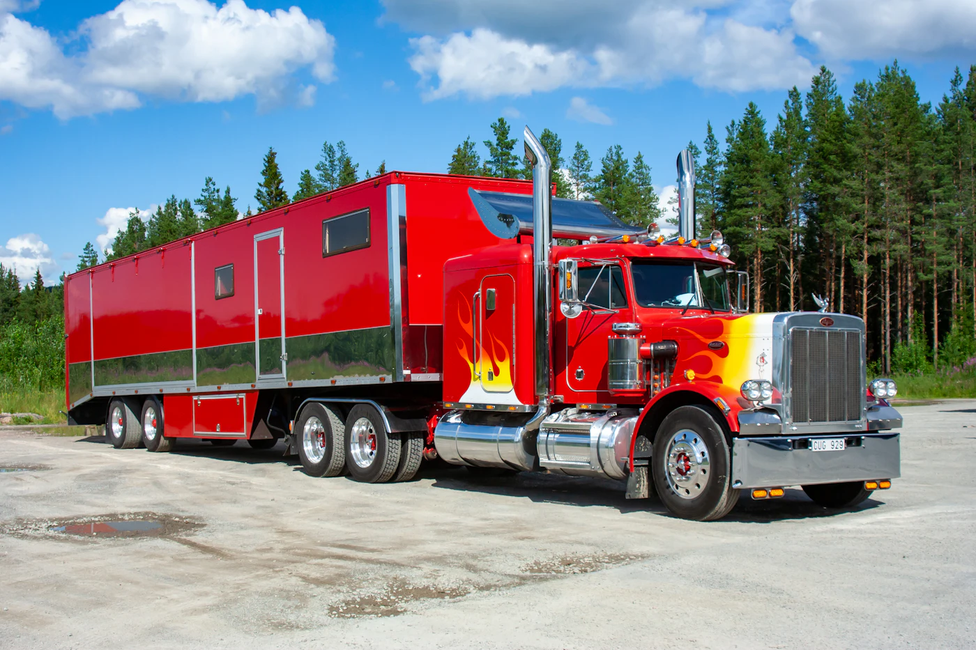 Red and white Peterbilt semi truck on the road
