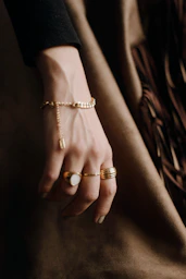 person wearing gold and diamond ring