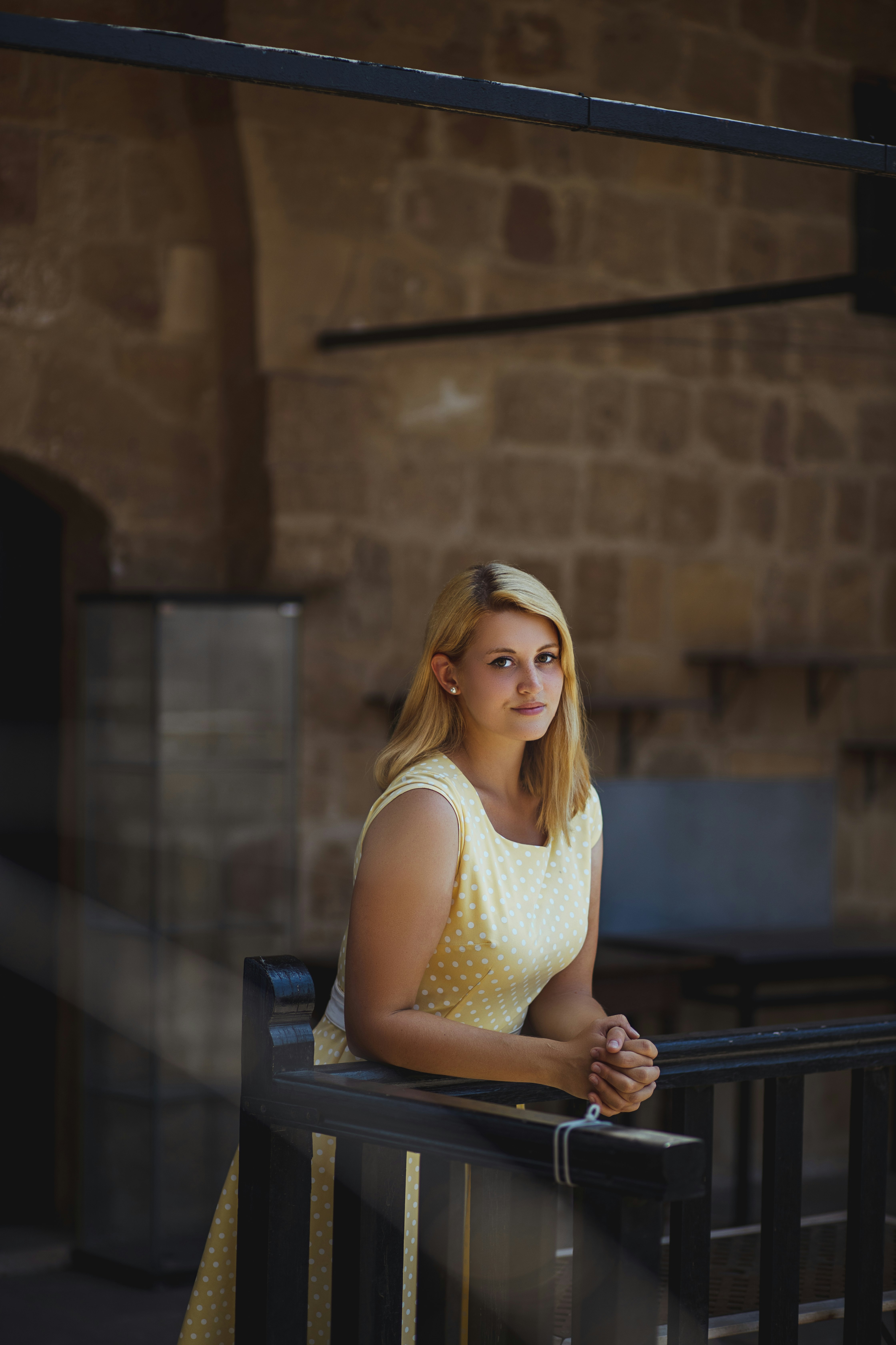 woman in yellow tank top sitting on chair