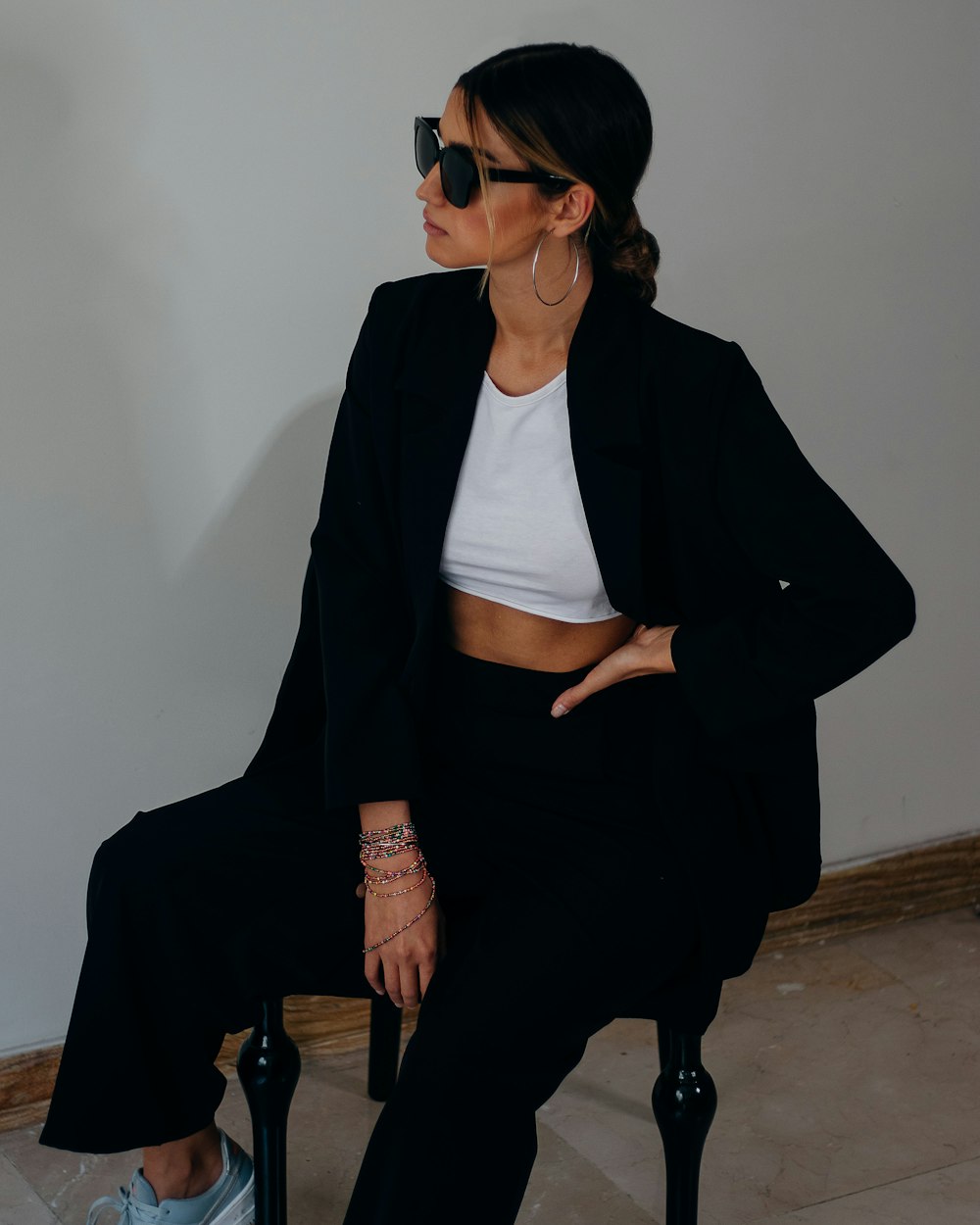 woman in black blazer sitting on brown wooden chair