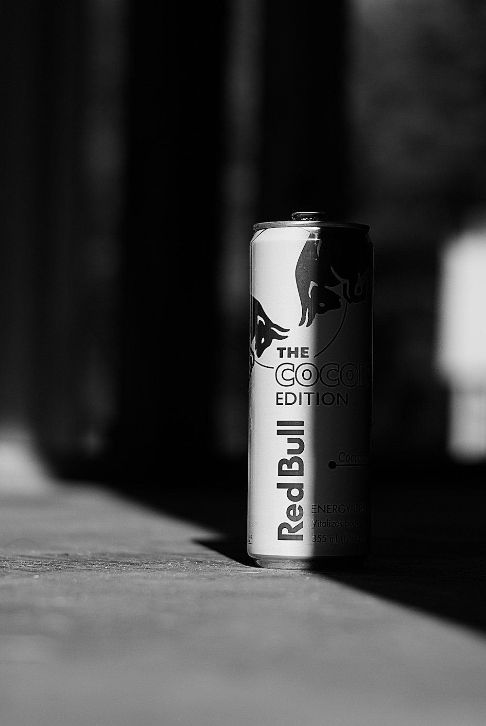 black and white can on wooden table