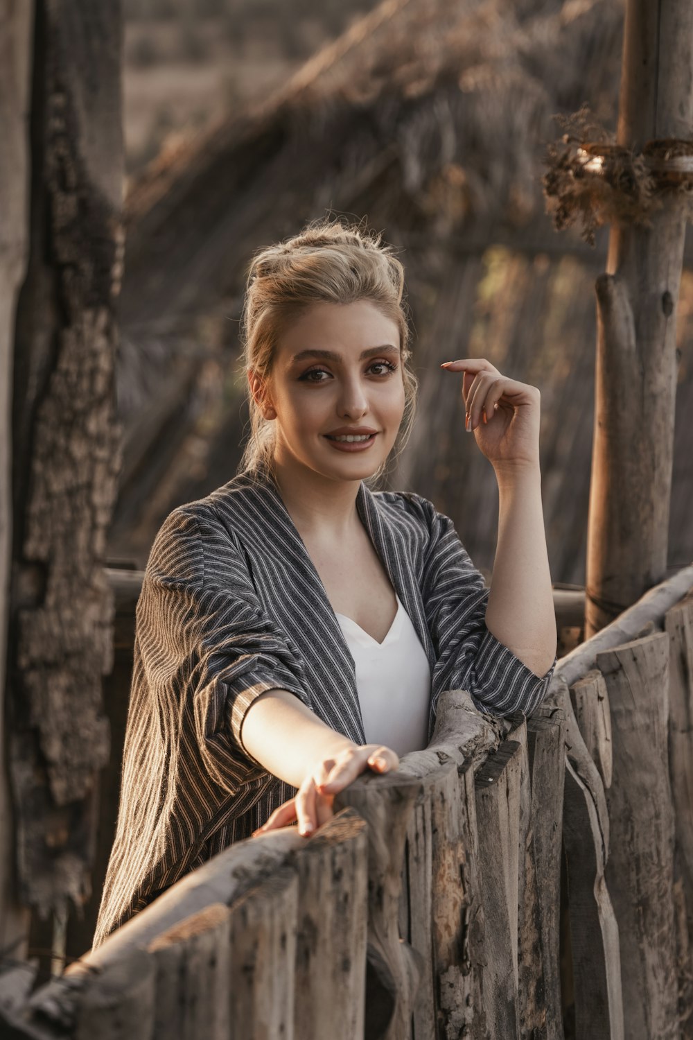 woman in black and white striped long sleeve shirt smiling