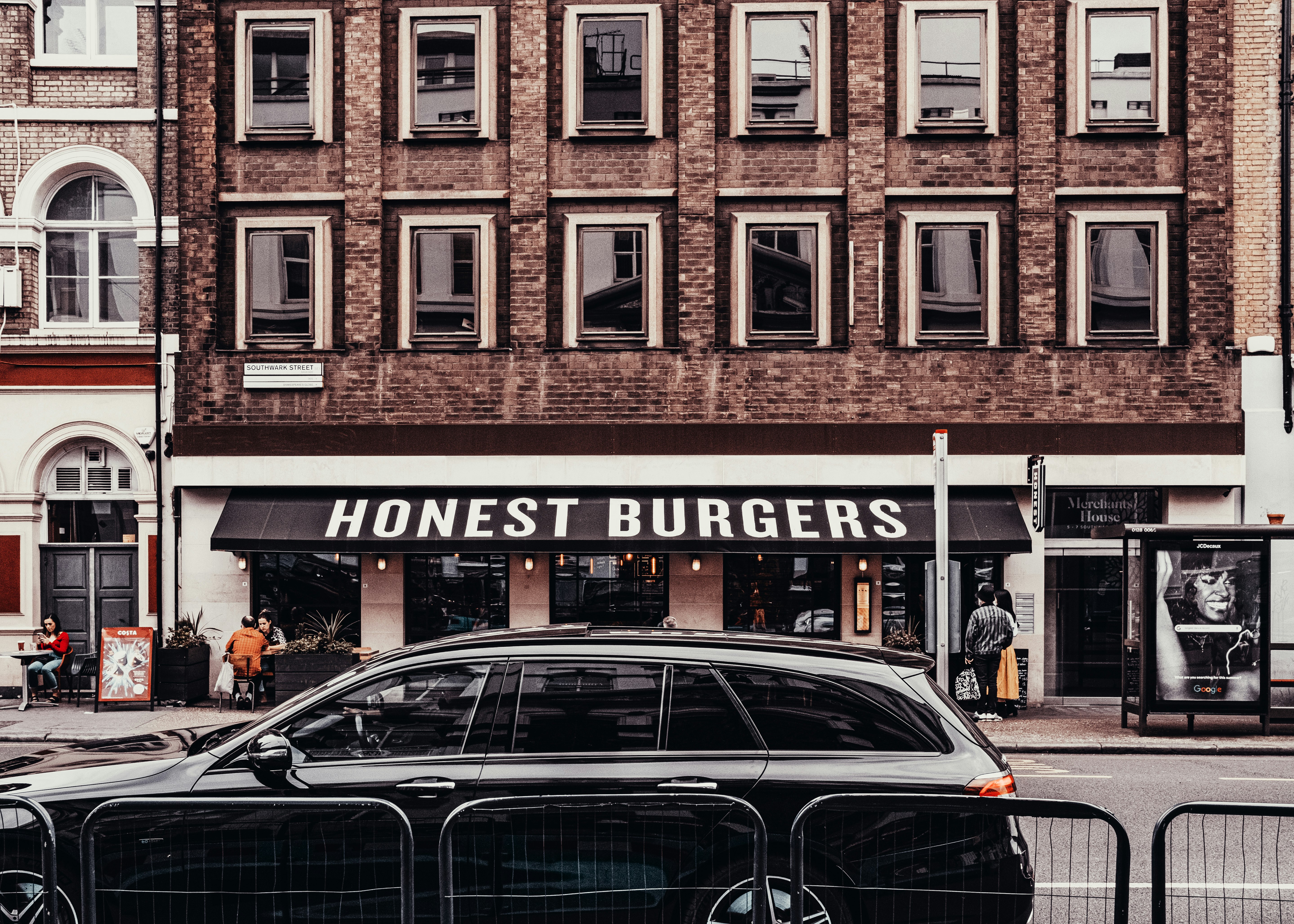 black sedan parked beside store