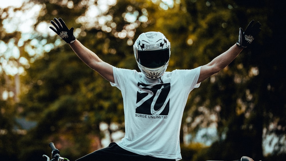 man in white and black nike crew neck t-shirt wearing black and white helmet