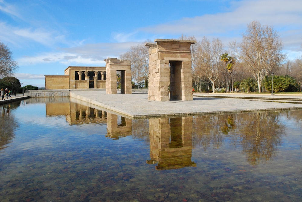 brown concrete building near body of water during daytime