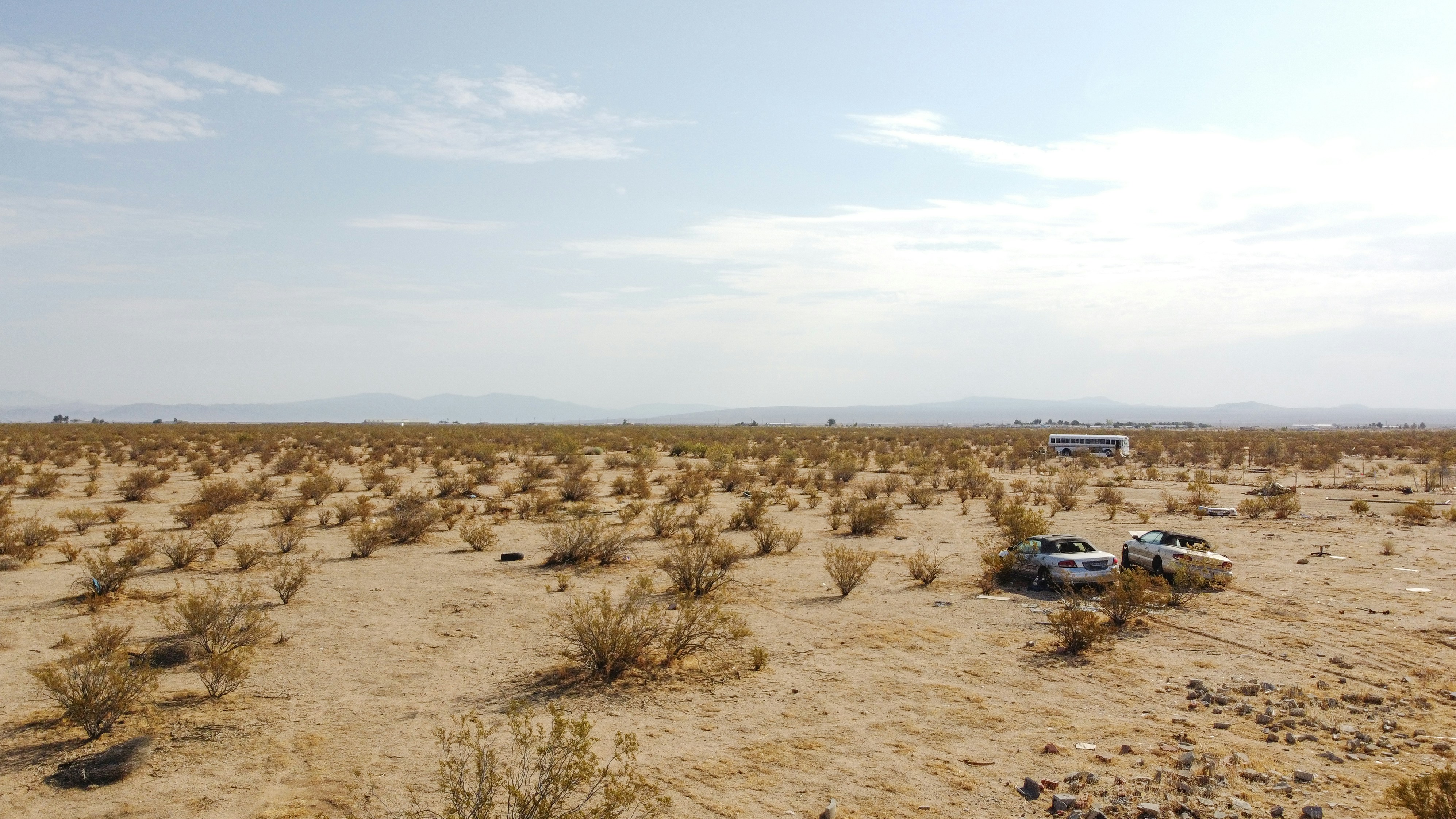 white car on brown sand during daytime