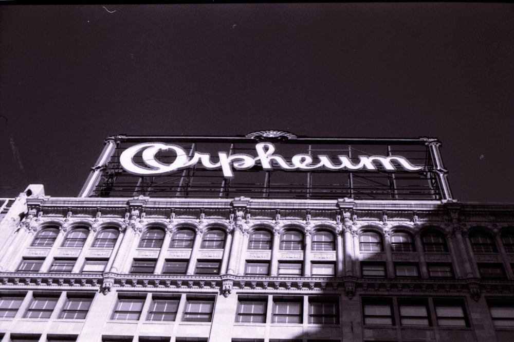 grayscale photo of building with lights turned on during night time