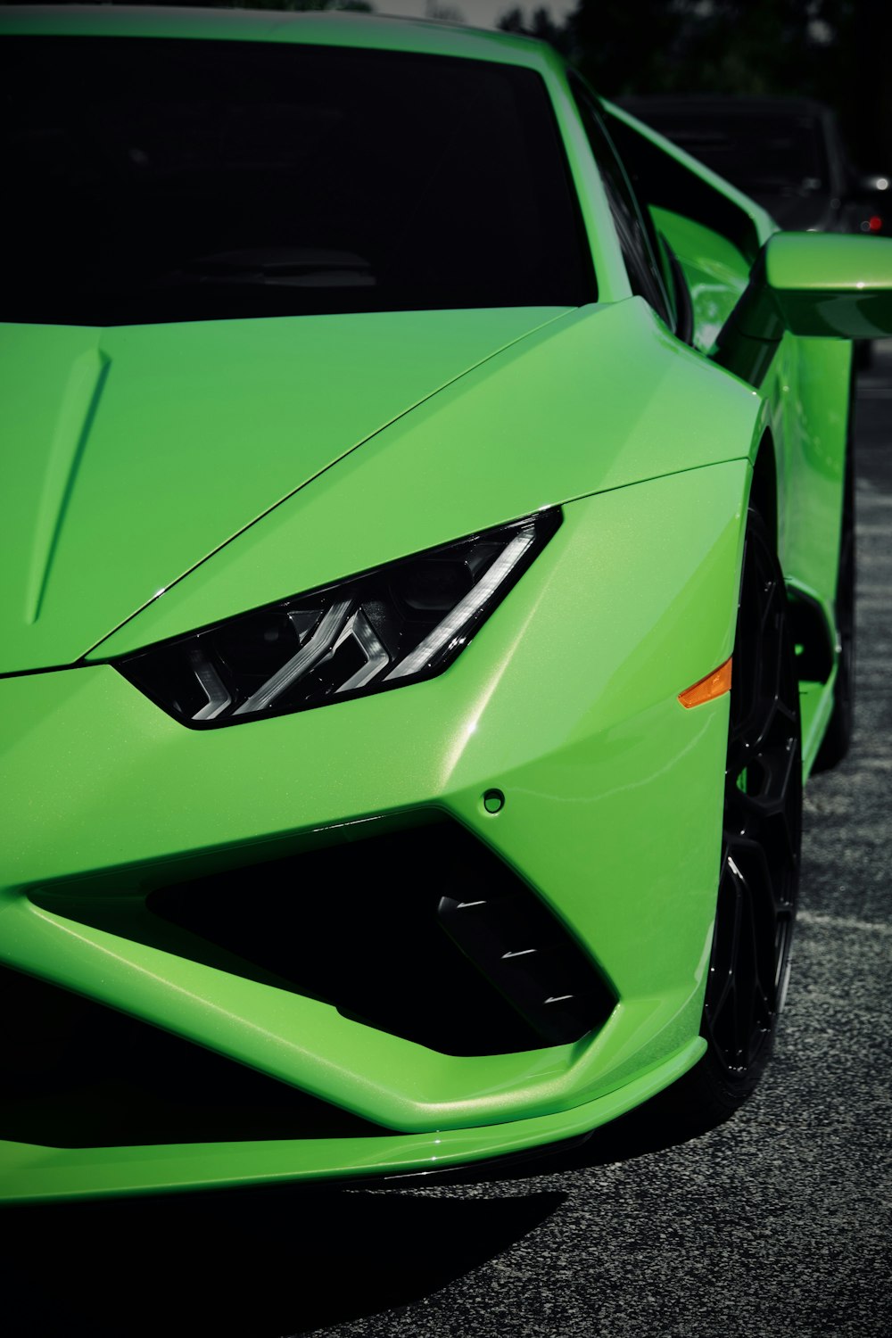 green lamborghini aventador parked on gray asphalt road during daytime