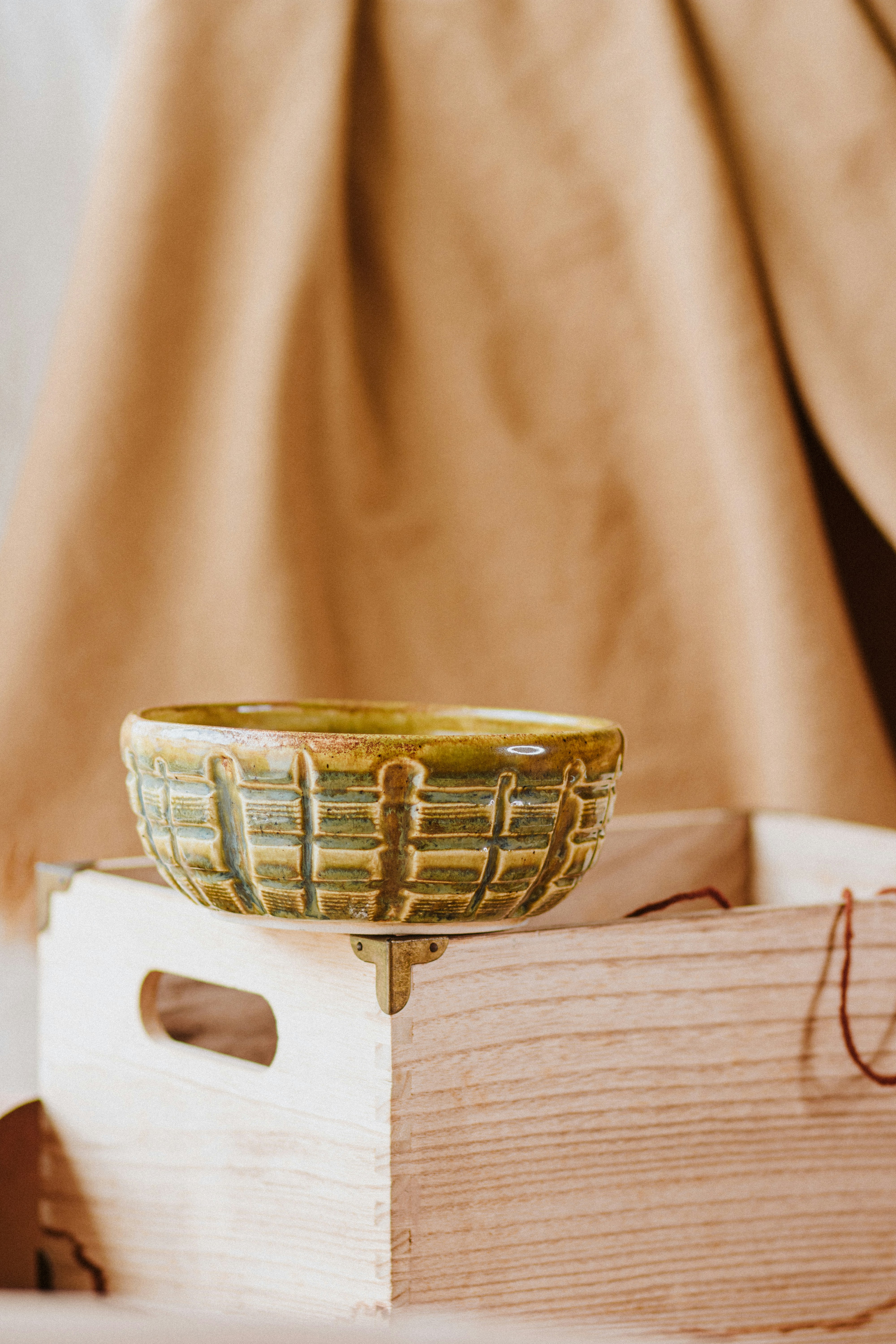 gold and silver round container on white textile