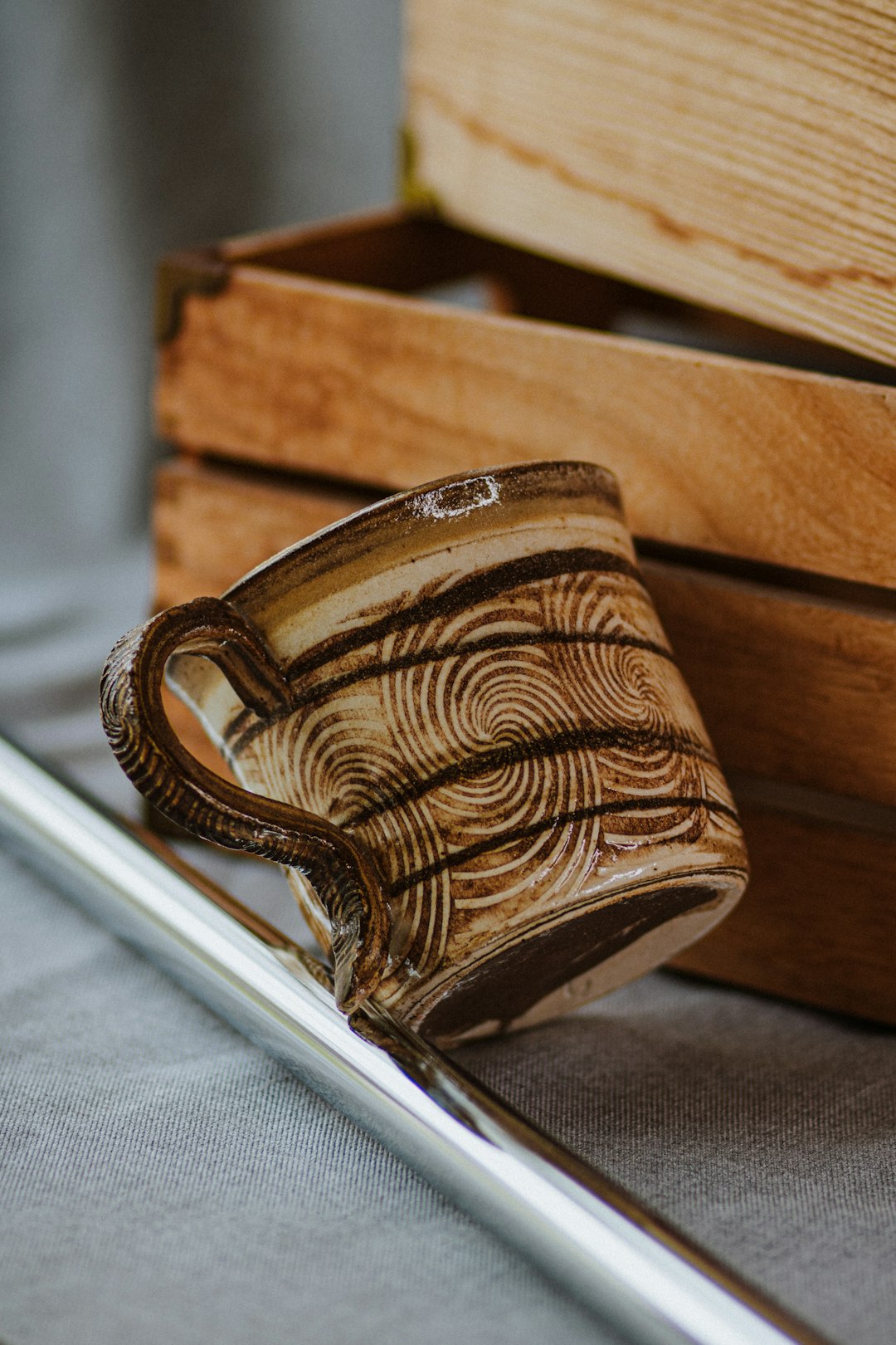 brown wooden box on white textile