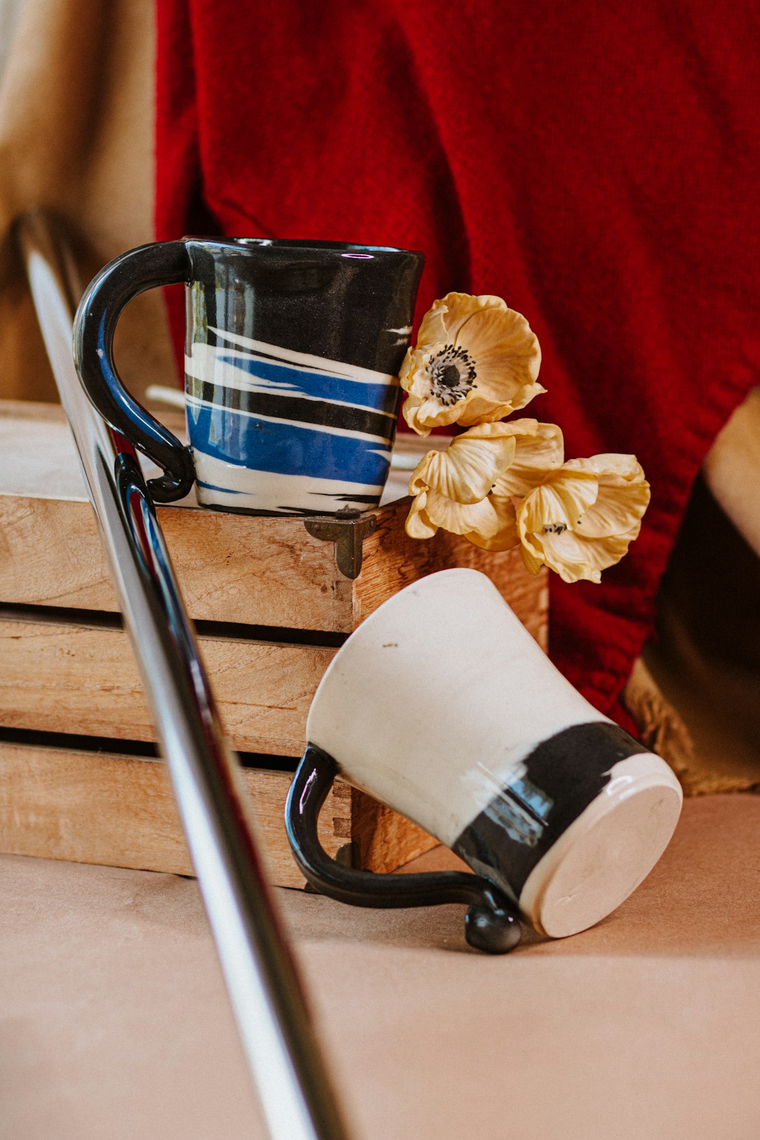 white and blue ceramic mug beside brown bear plush toy