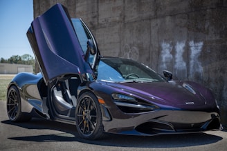 purple lamborghini aventador parked near gray concrete wall