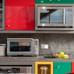 silver microwave oven on black marble counter top