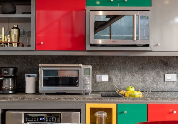 silver microwave oven on black marble counter top