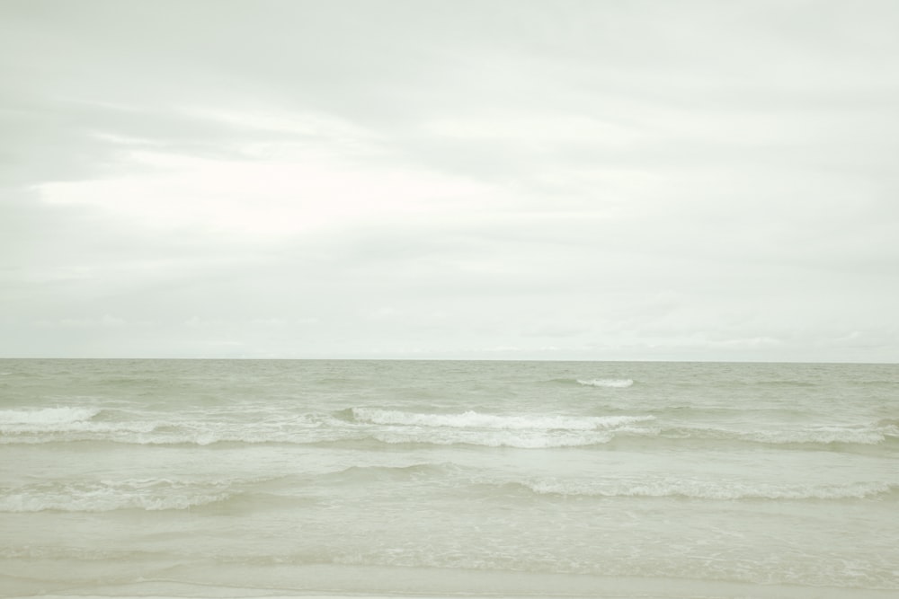 ocean waves under cloudy sky during daytime