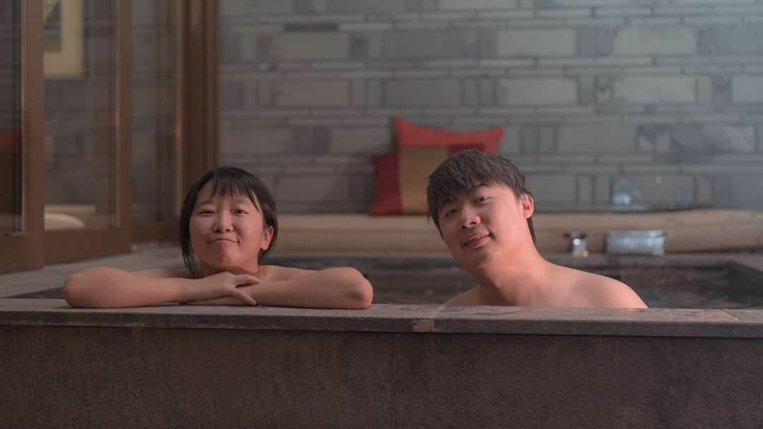 2 boys in bathtub with water