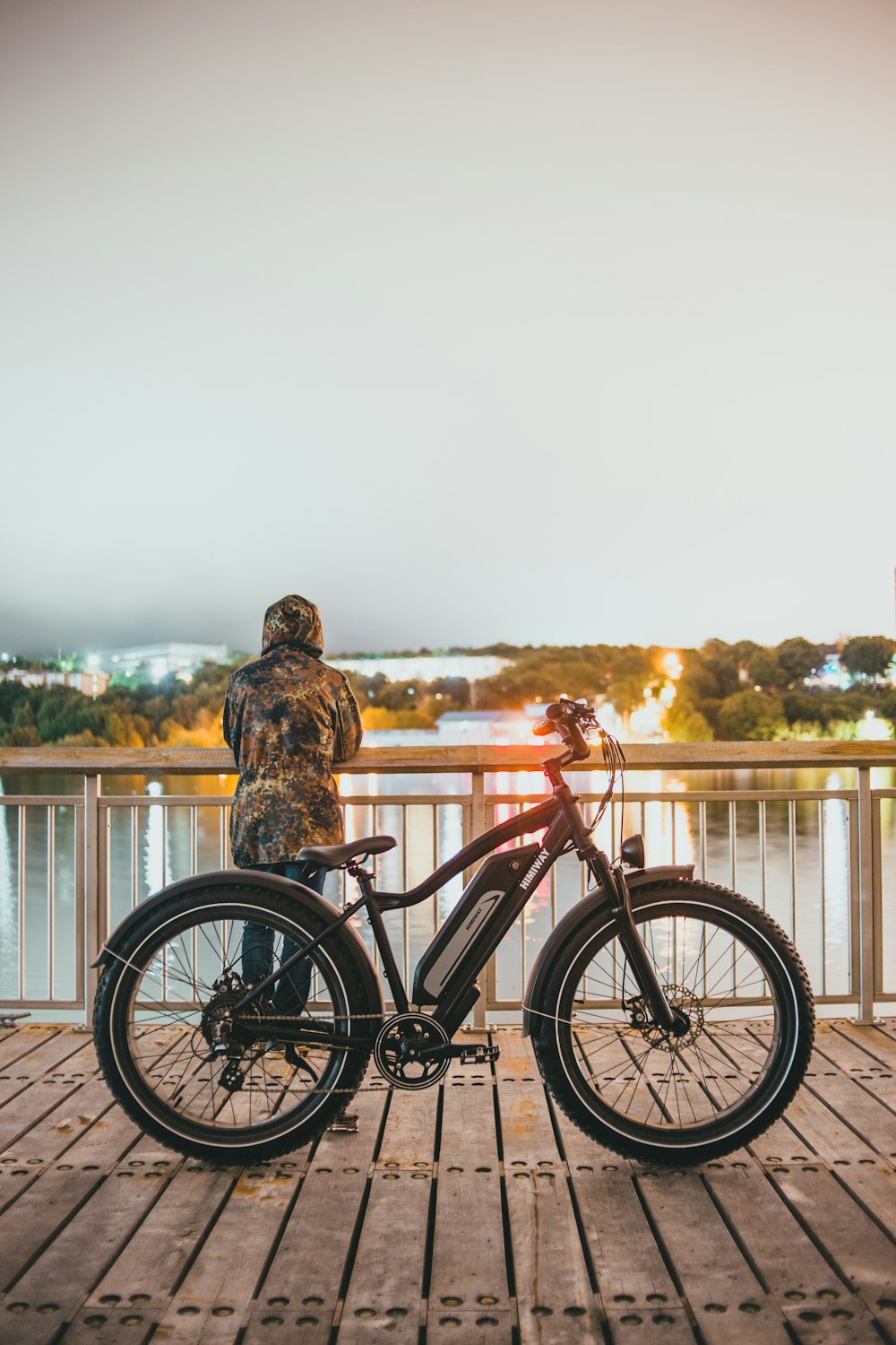 man in brown and black jacket and brown pants riding on red bicycle during daytime