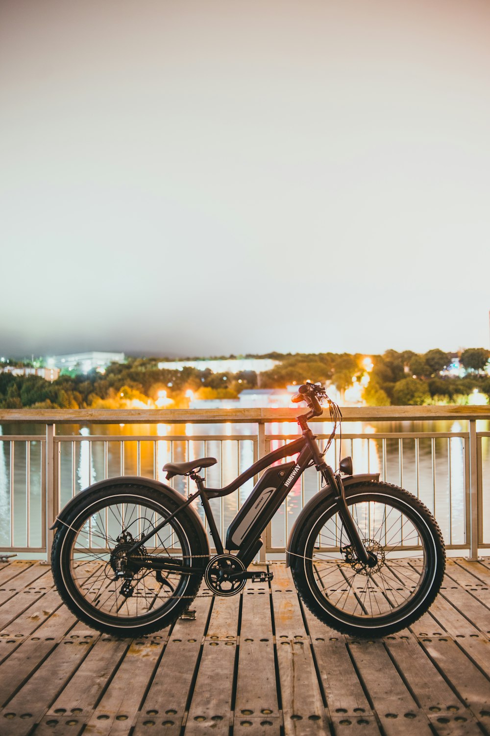 red and black bicycle on brown wooden dock during daytime