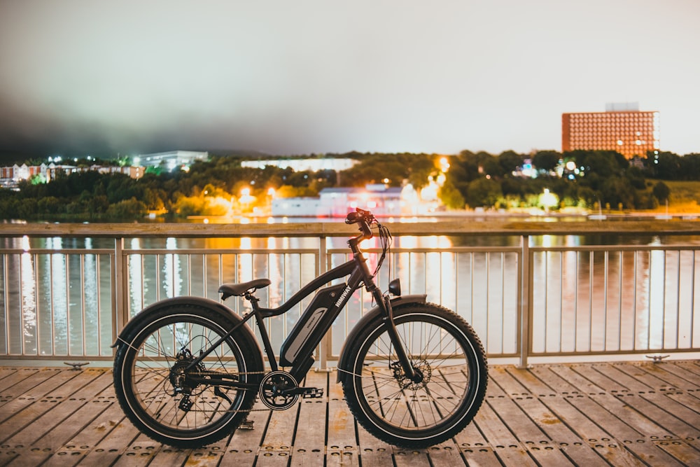 black and red bicycle on brown wooden dock during daytime