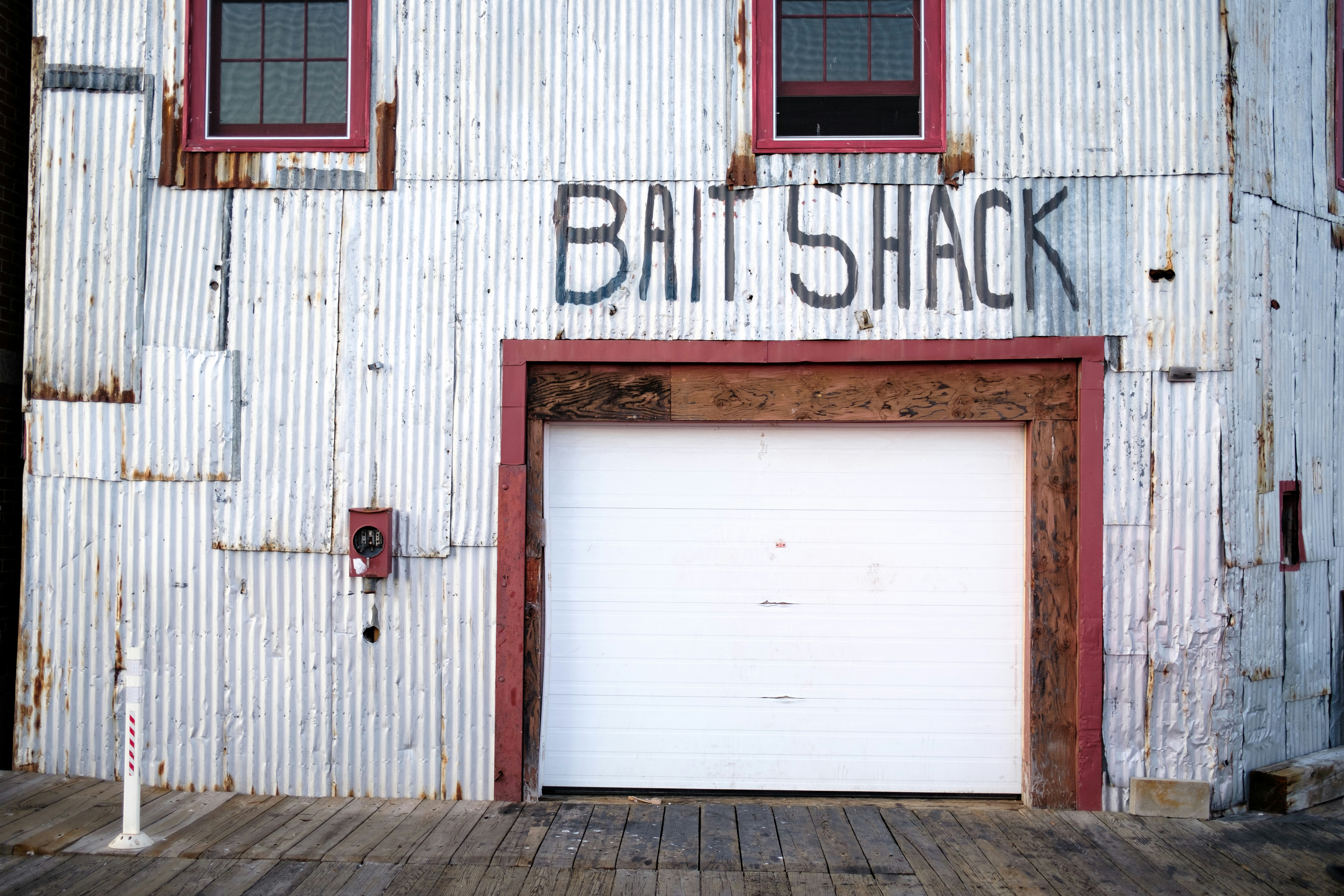 white wooden door with red door lever