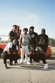 A diverse group of people wearing trendy streetwear outfits.