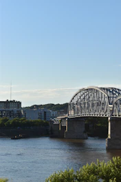 A wide-angle shot of a newly constructed steel and concrete bridge spanning the Hooghly River under a clear sky.