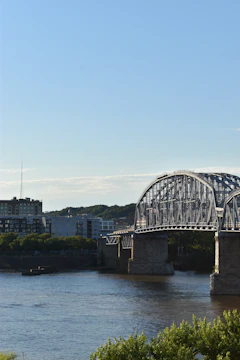 A wide-angle shot of a newly constructed steel and concrete bridge spanning the Hooghly River under a clear sky.