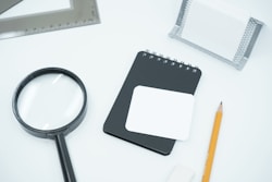 black magnifying glass on white paper