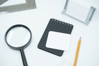 black magnifying glass on white paper