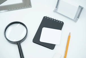 black magnifying glass on white paper