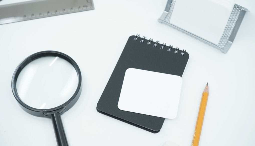 black magnifying glass on white paper