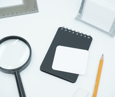 black magnifying glass on white paper