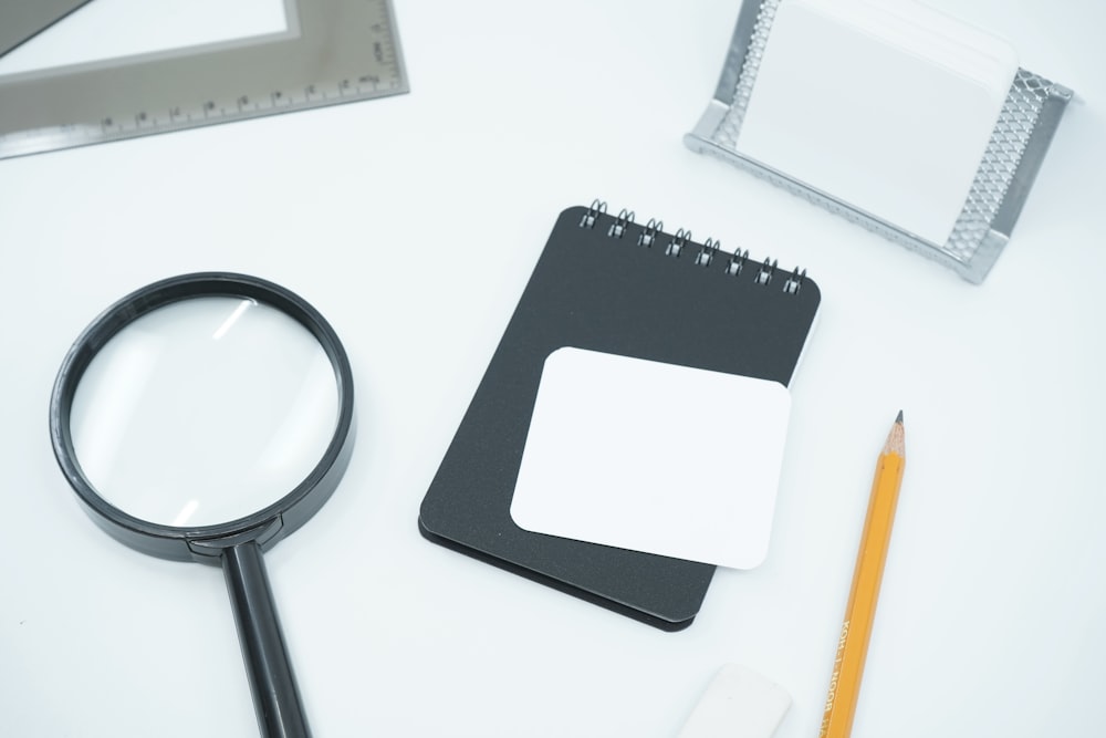 black magnifying glass on white paper