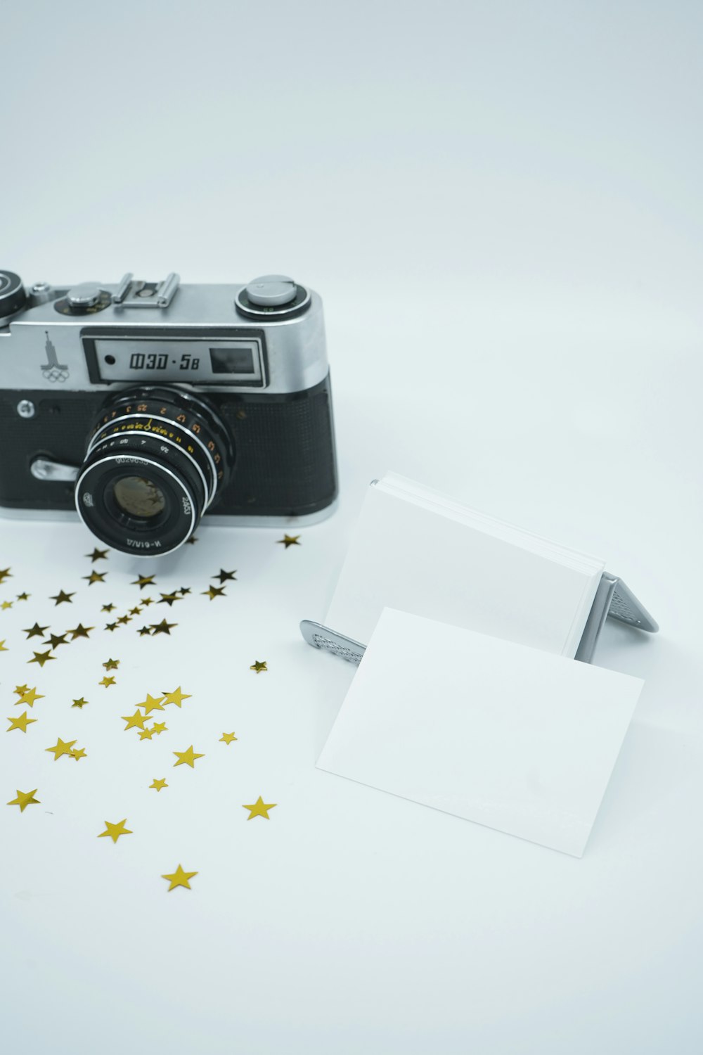 black and silver dslr camera on white paper