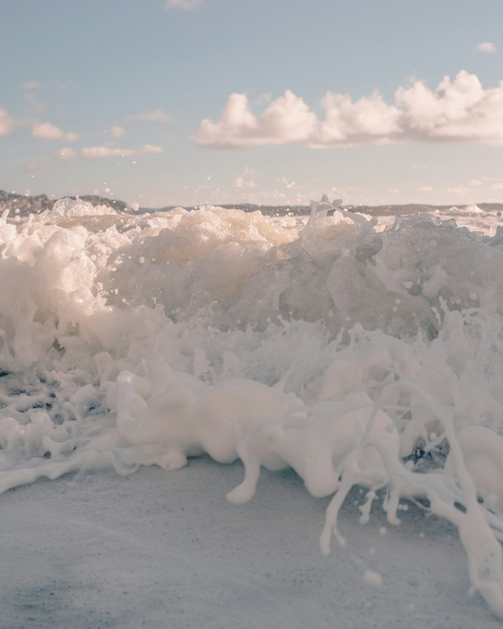 white ice on white sand during daytime