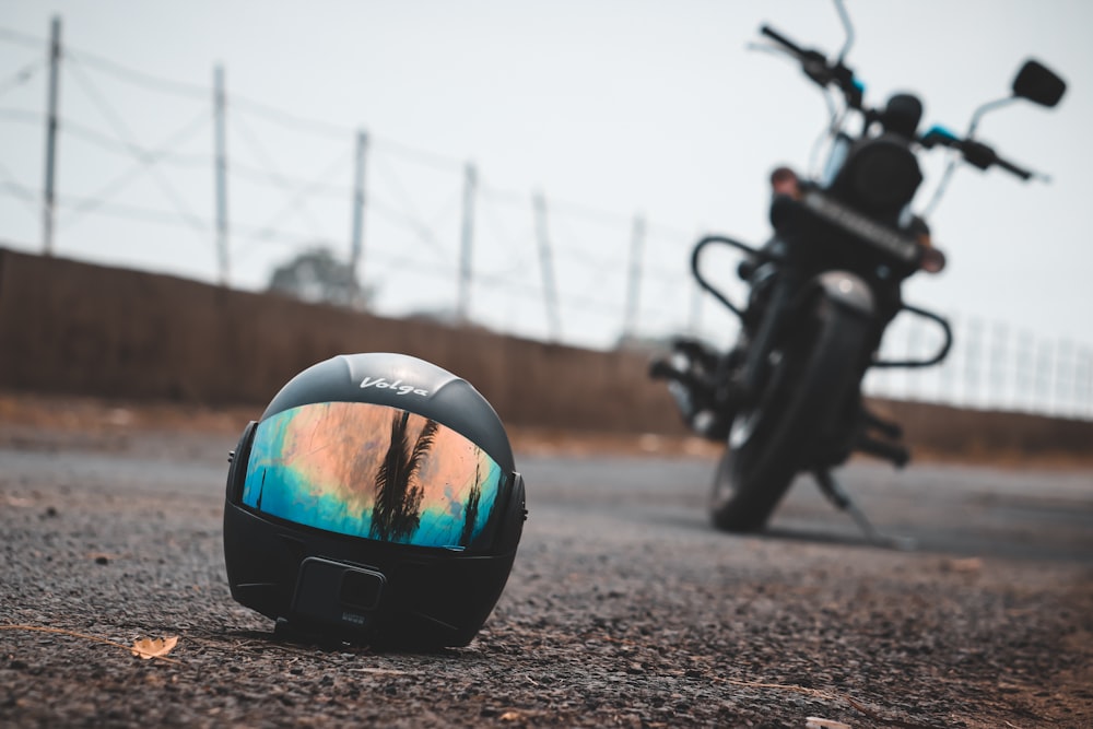black motorcycle helmet on road during daytime