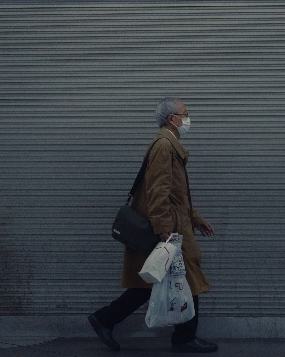 woman in brown coat holding white plastic bag