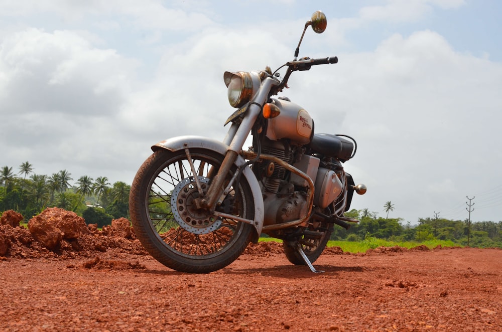 black and gray motorcycle on brown dirt road during daytime